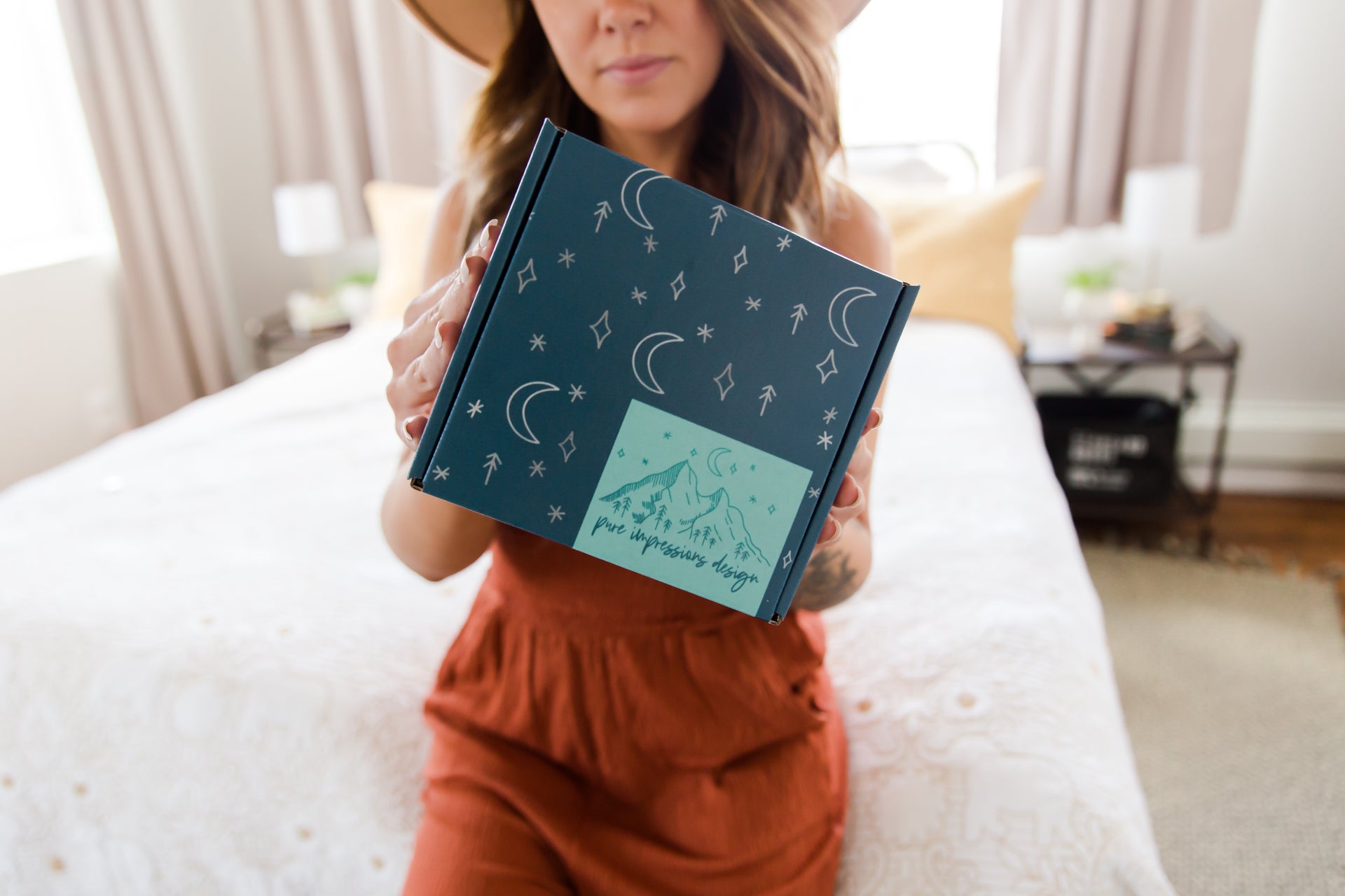 Woman holding Pure Impressions Design Subscription Box